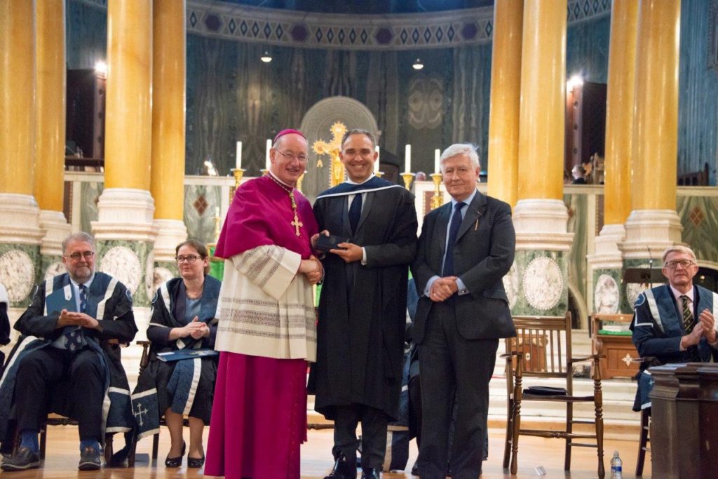 The Rt Rev Richard Moth MA, JCL, KC*HS, Bishop of Arundel and Brighton, and Chair of the Board of Governors of St. Mary's University; Sir Mark Sedwill, Cabinet Secretary, Head of the Civil Service and National Security Adviser; and Dr. Christopher Moran, Chairman of Co-operation Ireland